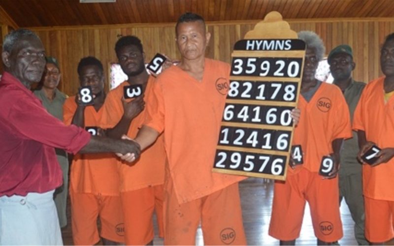 Gizo inmates donate self-crafted hymnal board to Church